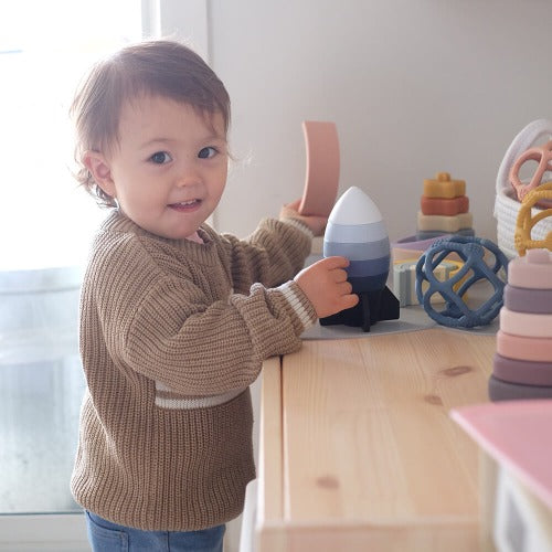 child playing with the stacking rocket