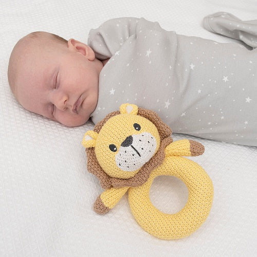 baby in swaddle wrap with knitted lion ring rattle