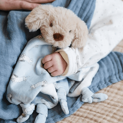 baby holding the barklife dog comforter