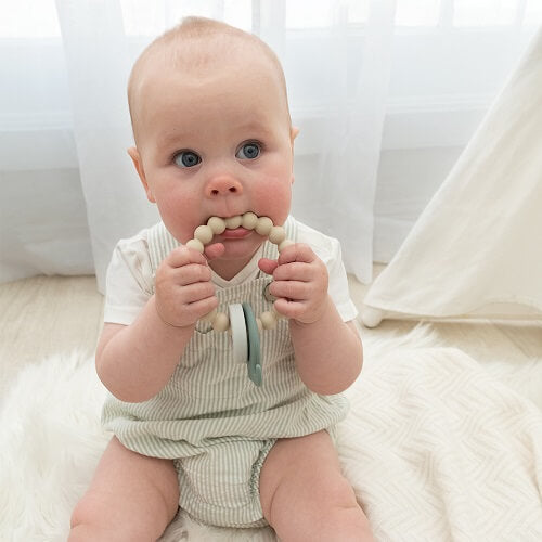 baby using the siicone elephant and ring teether