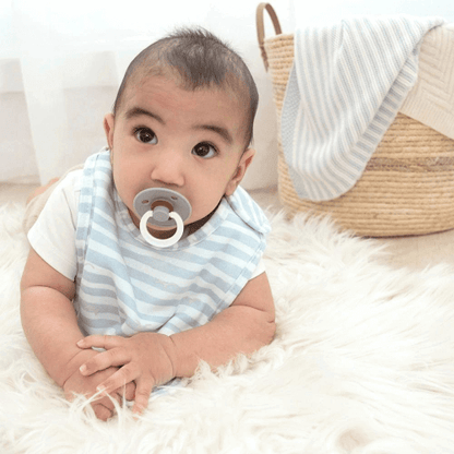 Baby wearing blue and white striped bib