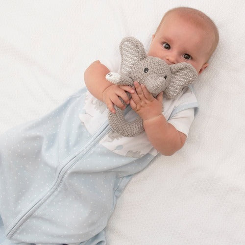 baby holding knitted elephant ring rattle