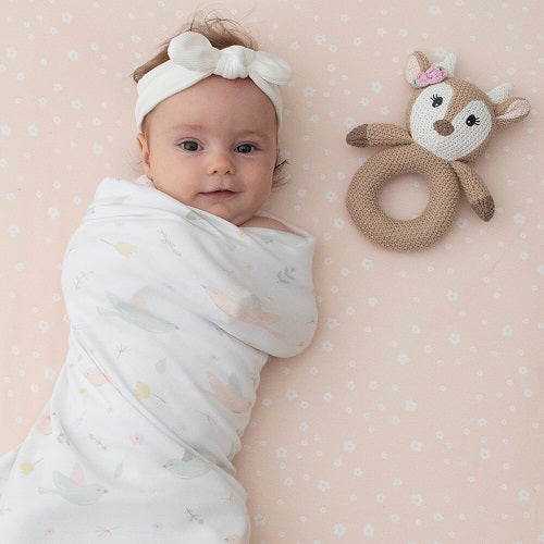 swaddled baby with fawn knit ring rattle