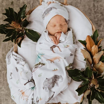 newborn in safari swaddle and beanie