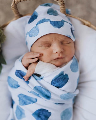 newborn in ocean skies swaddle and beanie