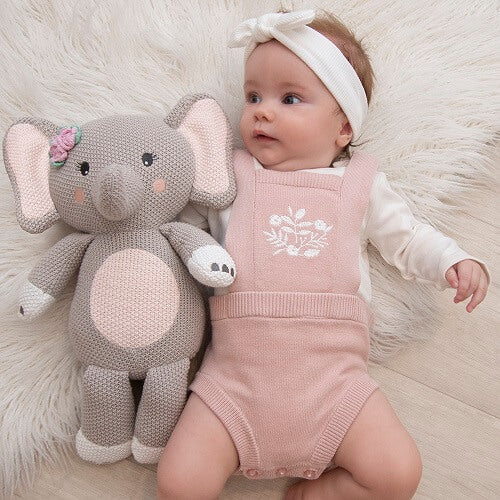 baby with elephant knitted toy