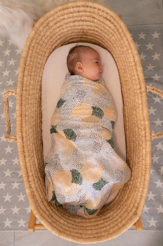 baby swaddled in patches muslin wrap