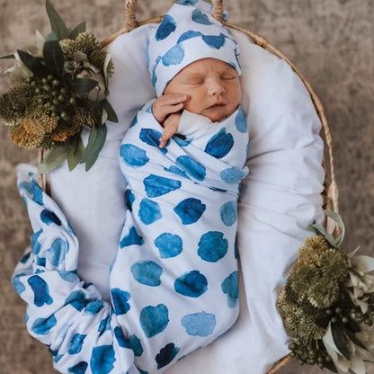 newborn in ocean skies swaddle and beanie