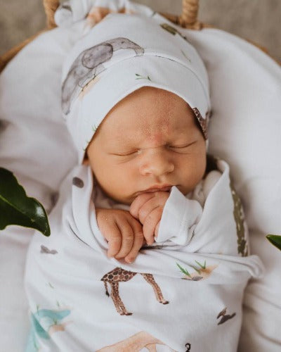 newborn in safari swaddle and beanie